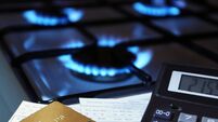 bank cards and a calculator on the background of a gas stove