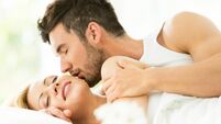 Man kissing woman in bed