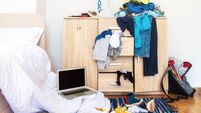 big mess in young boy's room, scattered things, unmade bed, food on floor