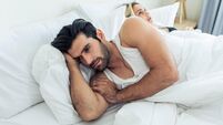 Caucasian young couple lying on bed with painful after fight argument. New marriage man and woman crying and feel heartbroken fo