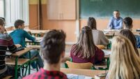 Rear view of high school students attending a class.