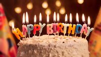 Birthday cake with candles, bright lights bokeh.Celebration.