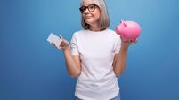 social insurance. mature woman with gray hair keeps her savings on a bank account on a studio background with copy space