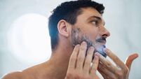 Handsome Man Washing his Face in the Bathroom