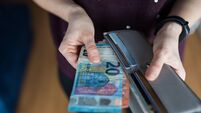 Woman taking out money from wallet