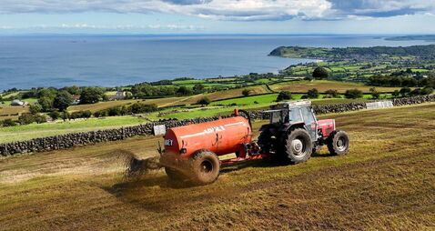 Aerial Photo of Massey Ferguson 390T Tractor and Abbey Tanker spreading manure slurry in a field on farm in UK 09-09-23