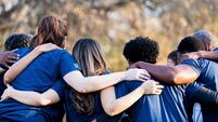 Friends linking arms in unity