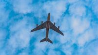 Emirates flight flying high in the sky