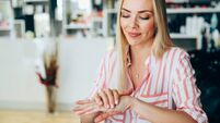 Woman applying moisturizing cream on hands