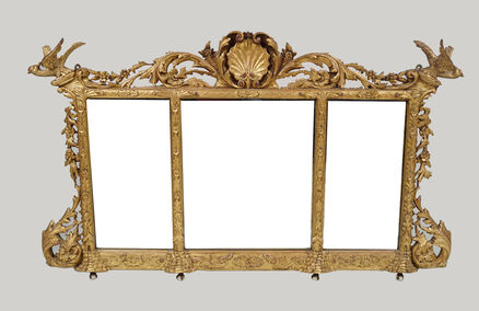 An Irish 19th-century carved giltwood overmantel at Sheppard's. An Irish 19th-century carved giltwood overmantel at Sheppard's.